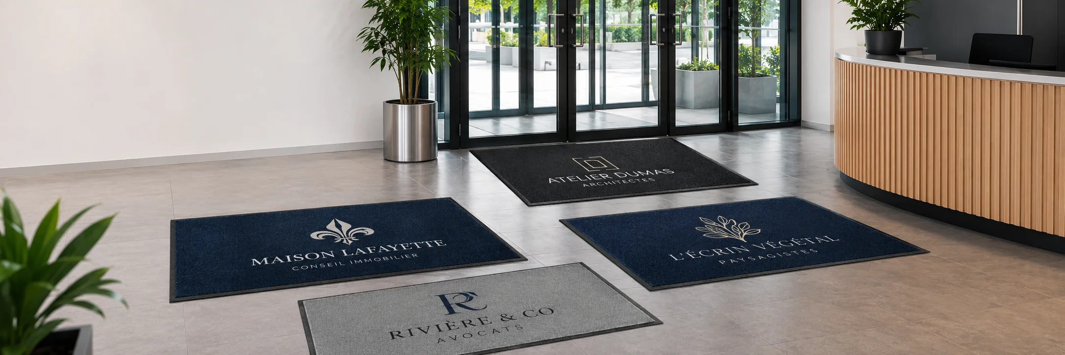 Banni&egrave;re r&eacute;aliste montrant plusieurs tapis d&rsquo;entr&eacute;e personnalis&eacute;s avec des logos fran&ccedil;ais dans un hall d&rsquo;accueil professionnel moderne, id&eacute;ale pour illustrer une page d&eacute;di&eacute;e aux tapis logo sur mesure pour entreprises.
